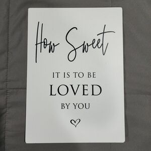 White Decorative Sign with Black Text